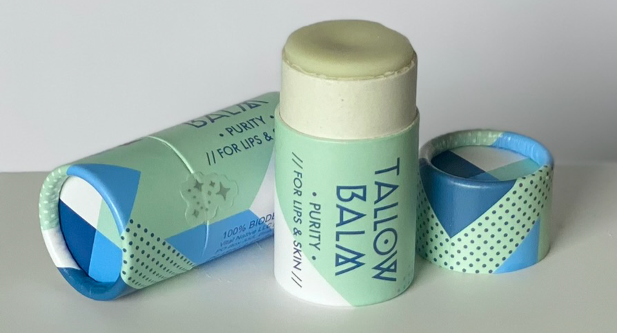 Purity balms, one open and one closed on a table.